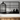 Black birdcage metal wall art above a console table