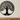 Matte black metal tree of life wall art in a modern hallway