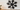Metal snowflake wall decor above a fireplace mantel