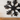 Metal snowflake wall decor above a fireplace mantel
