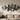 Modern metal wall art casting shadows above a sofa in a bright living room