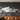 Formula 1 metal print above a media console in a modern living room