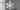 Silver metal snowflake Christmas wall ornament on a living room wall above a sofa, with soft winter light.