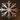 Metal snowflake wall ornament casting shadows on living room wall