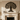 Iron tree of life wall sculpture above a fireplace in a cozy living room