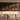 Large iron wall sculpture on a living room wall above a sofa