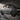 Close-up of metal car silhouette wall decor with dramatic shadows on an accent wall