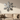 Metal snowflake wall art above a sofa in a cozy living room