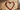 Powder-coated red metal heart wall decor on patio brick wall with elongated shadow