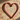 Powder-coated red metal heart wall decor on patio brick wall with elongated shadow