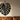 Metal botanical leaf pattern as wall art in a cozy living room setting
