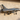 Metal fighter jet wall art on outdoor patio wall in sunlight