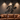 Man cave interior featuring large metal sports silhouette wall art above a leather sofa with track lighting creating shadows
