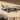 Fighter jet metal wall art on an outdoor patio wall with warm sunset lighting