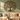 Metal tree of life wall art with butterflies above a sofa in a living room