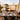 Luxurious dining setup in a rooftop restaurant overlooking the cityscape at sunset.