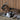 Goats relaxing inside a wooden barn in a tranquil rural environment.
