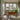 Bright dining area with wooden furniture and large windows showcasing natural light.
