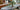 Elegant indoor setting with a potted plant on a leaf-patterned table in a cozy seating area.