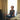 Adult woman practicing meditation on her bed surrounded by a calm bedroom atmosphere.