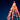 Colorful bokeh lights forming a Christmas tree against a dark blue sky.