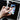 Hand interacting with smartphone on marble desk, featuring stylus and notebook.