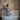 A stylish woman enjoying a tranquil moment in a chic brick-walled bathroom.