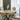 Elegant dining room featuring a modern table, chairs, and a decorative statuette, exuding luxury and style.