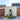 Contemporary house exterior featuring a stylish wooden facade, entrance gate, and vibrant garden.