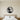 Astronaut on a looping tether floating above a planet inside a round frame