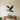 Black steel silhouette of a bald eagle landing on a branch