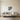 Birch branch metal wall art hanging above a bed in a bedroom
