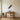 Birds taking flight metal wall art hanging above a living room sofa