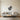 Butterfly on a flower metal wall art hanging on a bedroom wall