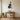 Cello metal wall art hanging beside a piano in a living room
