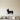 Black steel silhouette of a corgi standing in profile