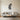 Eucalyptus branch metal wall art hanging on a bathroom wall
