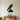 Black steel silhouette of a falcon perched on a rock