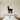 Black steel silhouette of a fluffy llama standing on grass