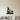 Black steel silhouette of a bearded gnome with a shovel and a mushroom