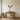 Deer skull wall art above a fireplace in a living room