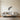 Eucalyptus branch metal wall art hanging on a bedroom wall