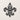Front view of the geometric fleur de lis design on a plain wall