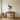 Geometric llama wall art beside a reading chair in a living room