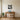 Geometric northern lights cabin wall art above a sofa in a living room