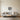 Geometric sloth wall art above a bed in a bedroom