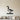 Low-poly goose standing on grass with its neck raised