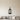 Silhouette of a hanging lantern with a hook and a candle inside