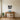 Lake loon wall art above a sofa in a cabin living room