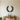 Black metal wall art of an open laurel wreath